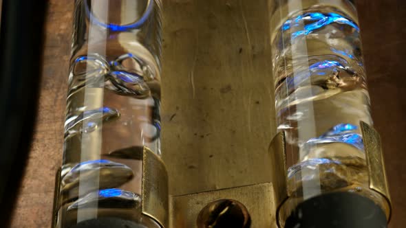 Air Bubbles in Two Glass Flasks Filled with Water