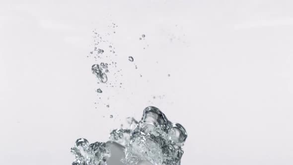 Slo-motion cube falling through water