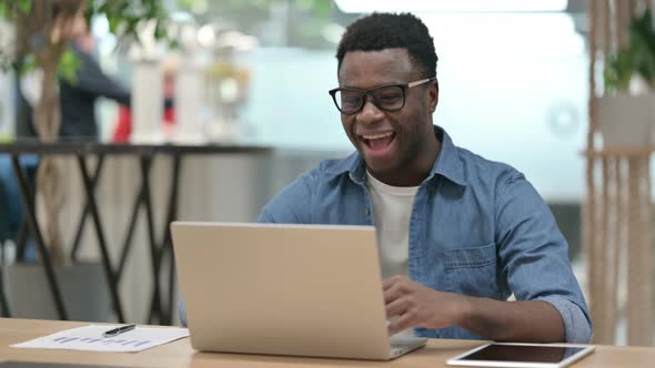 Young African Man Talking on Video Call on Laptop