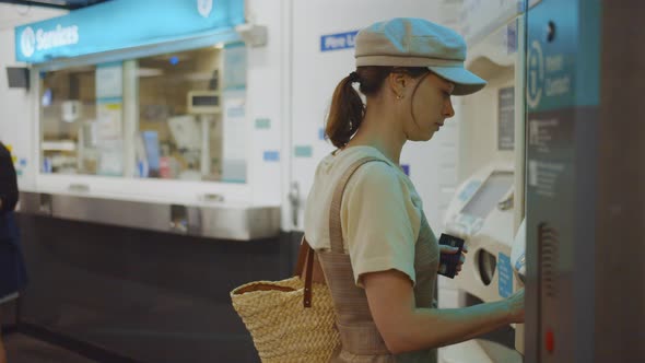 Young woman buying tickets in the subway