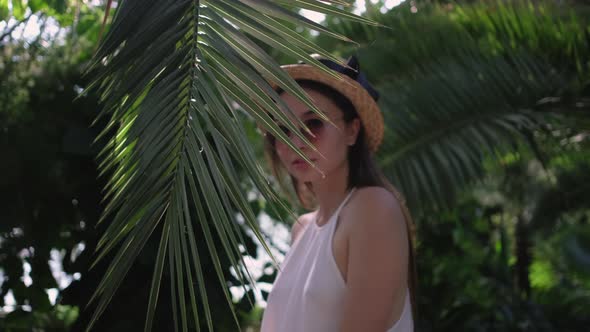 Portrait of a Young Woman with Palm Leaf