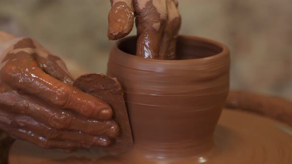 Old Woman Potter Working on Potter Wheel Making a Clay Pot