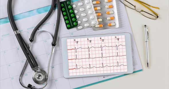 Medical Worktable Doctor Desk with Heart Cardiogram of Wave on Cardiography Heart Report Analysis