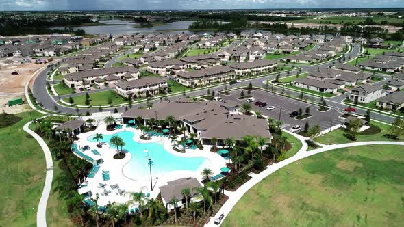 Aerial view of an upper middle class lakefront neighborhood subdivision with single family homes and