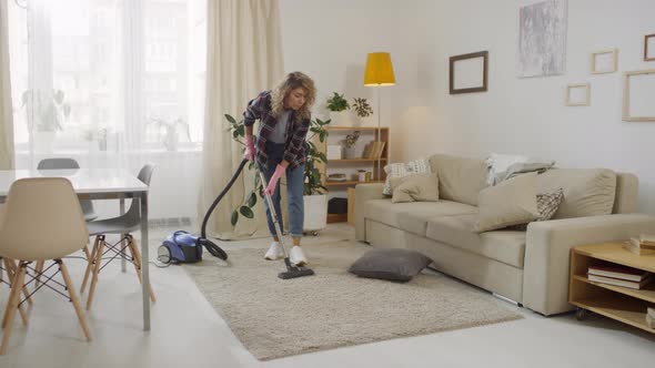 Sequence of Woman Vacuuming Carpet