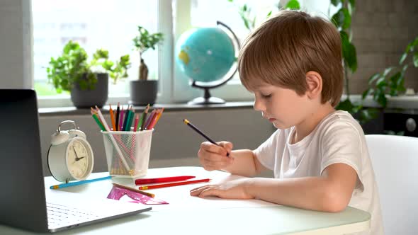 Happy Child Doing Homework at Home Smiles and Laughs