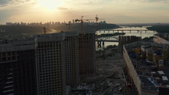 Top Aerial View of Building Construction Site in City at Sunset