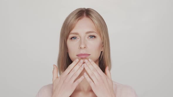 Studio portrait of young, beautiful and natural blond woman.