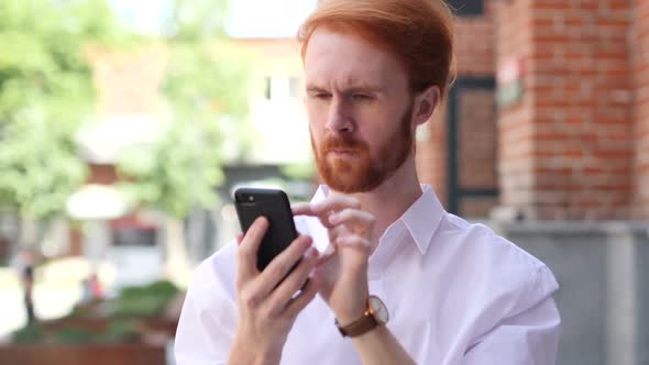 Man Using Smartphone While Standing Outside Building