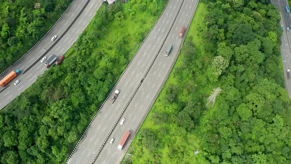 Flyby drone over three parallel roads passing through the Jungles of the Western Ghats of India