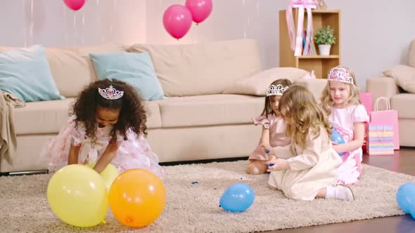 Girls Playing with Balloons on the Floor alt