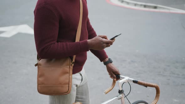 African American man using his phone in the street