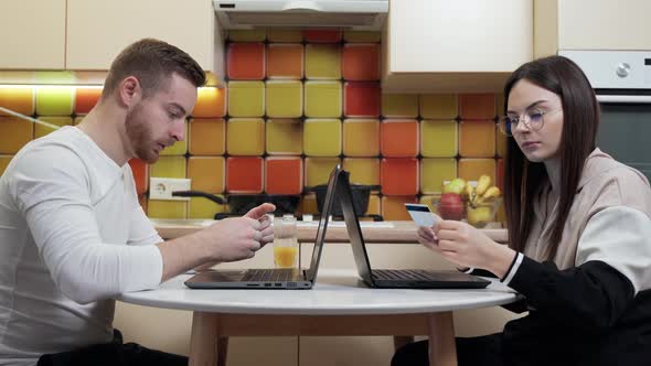 Young couple doing online shopping at home during quarantine