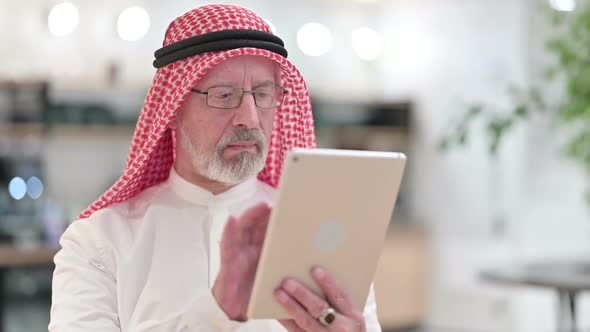 Attractive Senior Old Arab Businessman Using Digital Tablet