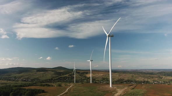 Camera Flight Over Landscape with Power Plant. Aerial View To Wind Turbine. Sustainable Electricity