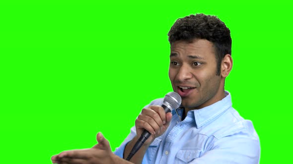 Energetic Entertainer Talking Into Microphone on Green Screen