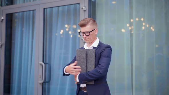 Businessman Standing Outdoors with Folder in Hand