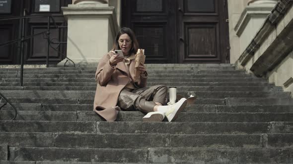 Young stylish woman eat fast food outdoors