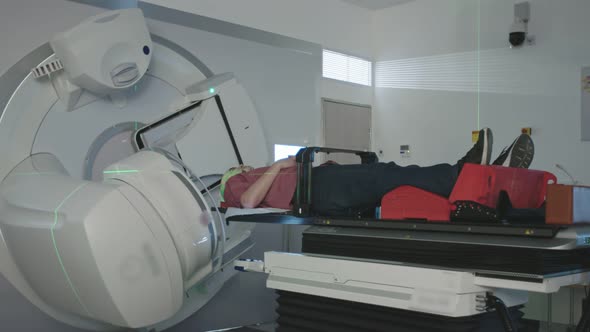 Patient Getting Radiation Therapy Treatment Inside A Modern Radiotherapy Room