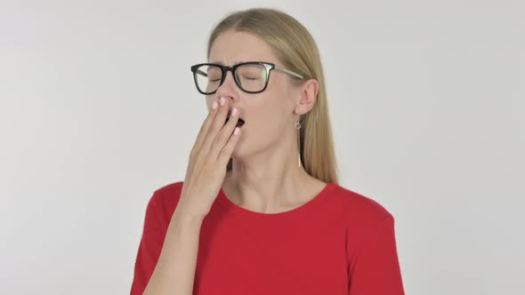 Tired Young Woman Yawning on White Background