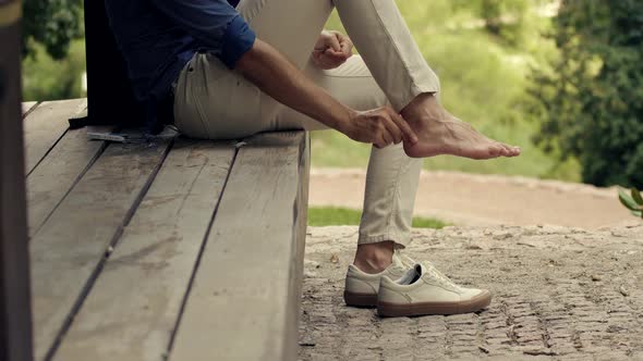 Putting A Band-aid On Leg Callus. Wrapping Foot With Plaster. Man Using First Aid Plaster.