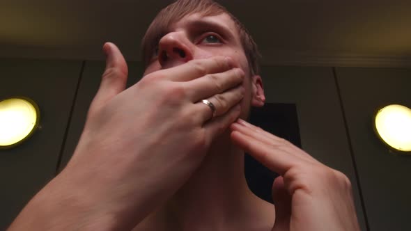 Man Applying Cream To His Face