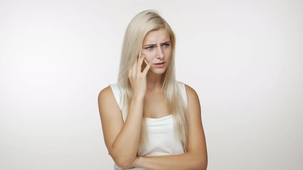 Irritated Girl with Blond Hair Speaking on Mobile Phone Have Unpleasant Conversation Holding