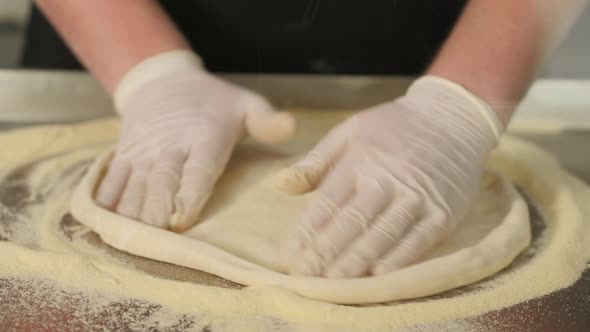 Chef Forming Dough for Pizza and Kneading It with Hands