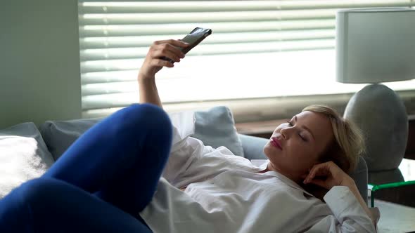 Weekend at Home, Woman Is Taking Selfie By Mobile Phone Lying on Couch