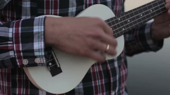 Young Man Plays Guitar – Ukulele