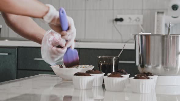 A Chef Making a Cake  Putting Cherry Filling in the Pastry Bag