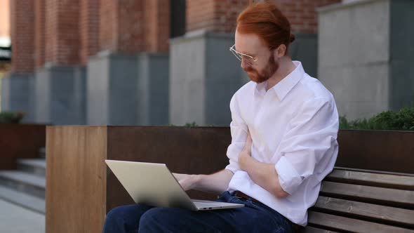 Pensive Designer Thinking while Working on Laptop