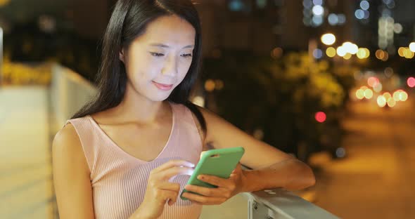 Woman use of mobile phone at night 