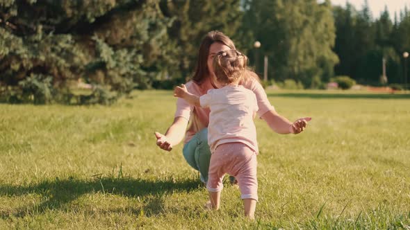 The Child Runs to Mom and Mom Hugs Him with Her Arms