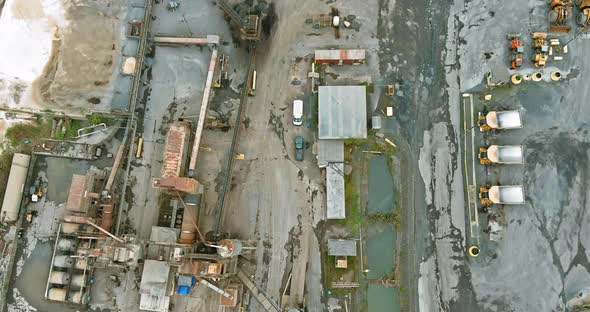 Aerial panorama view dumpers and machines are working in the quarry mine for special equipment