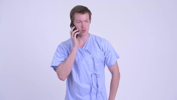 Young Man Patient Thinking While Talking on the Phone