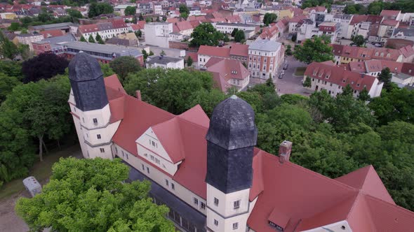 aerial of the 2 towers of Köthen castle in Germany, rotating drone shot