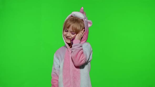 Little Kid Girl Daughter in Unicorn Pajamas Using Speaking Talking on Mobile Cell Phone with Mother