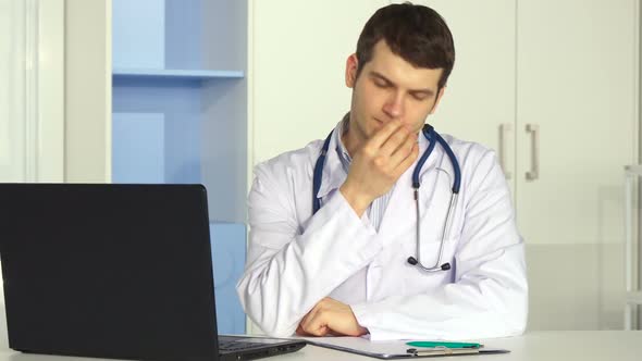 Male Doctor Gets Tired at the Office