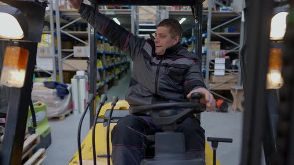 Joyful Caucasian Man in Uniform Driving Industrial Autoloader Forklift Waving Away Talking Smiling
