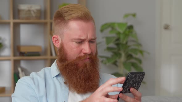 Redhead Man Spend Weekend at Home Using Smartphone Device Texting Sms Share Messages to Friends in
