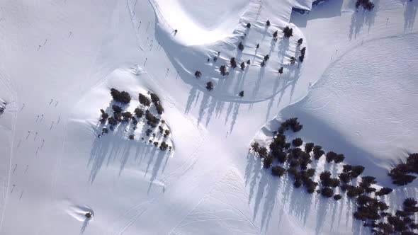 Aerial view of People Skiing and snowboarding on hill, Ski Resort. Drone flies over Skiers Skiing do