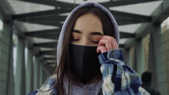 Young woman takes off medical mask. Female breathes deeply and looking at camera. Health care and me