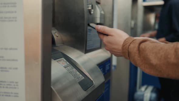 Closeup of Man Making Payment Through NFC in Train Station Atm Mobile Phone Contactless Pay for Bill