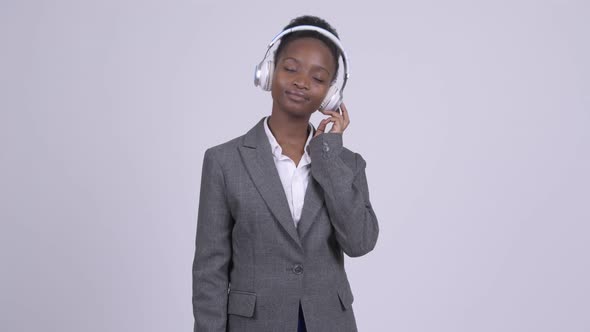 Young African Businesswoman Listening To Music and Looking Guilty