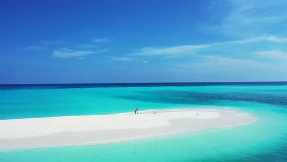 Wide above tourism shot of a sunshine white sandy paradise beach and aqua blue water background in v