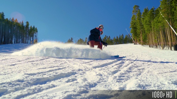 Slow Motion of Skier Spraying Snow at Camera