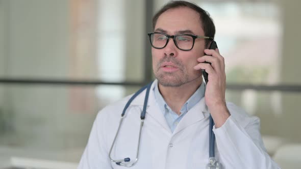 Middle Aged Doctor Talking on Smartphone