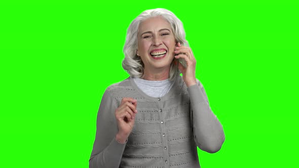 Happy Senior Woman Talking on Transparent Phone