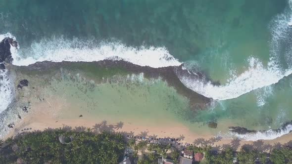 Foaming Ocean Waves Roll on Sandy Beach at Green Palms